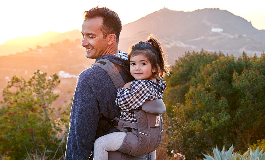 Dad is using an Ergobaby Baby carrier