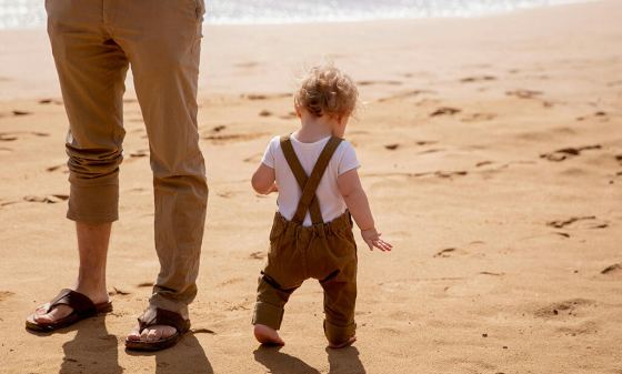 Baby and Dad by the beach