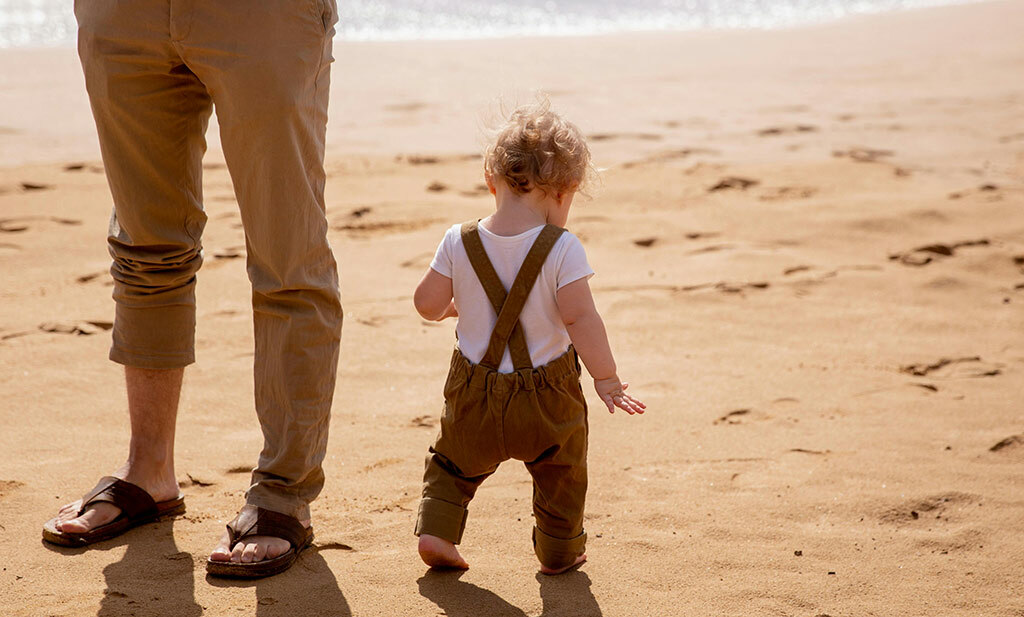 Baby and Dad by the beach