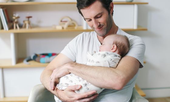 Dad holding a baby sleeping