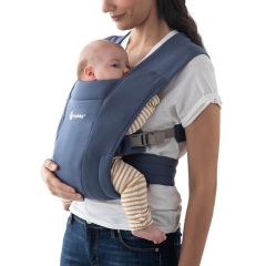 Mom wearing baby inward facing in Soft Navy Embrace Baby Carrier