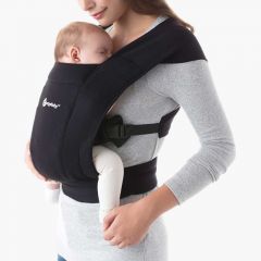Mom wearing baby inward facing in Pure Black Embrace Baby Carrier